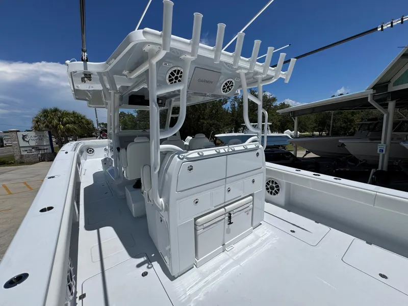 Slide: The Image of 2026 Invincible 46 Catamaran with spacious deck and modern amenities, docked under clear skies. - 34