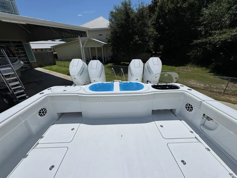 Slide: The Image of 2026 Invincible 46 Catamaran with four outboard engines, docked outdoors. - 39