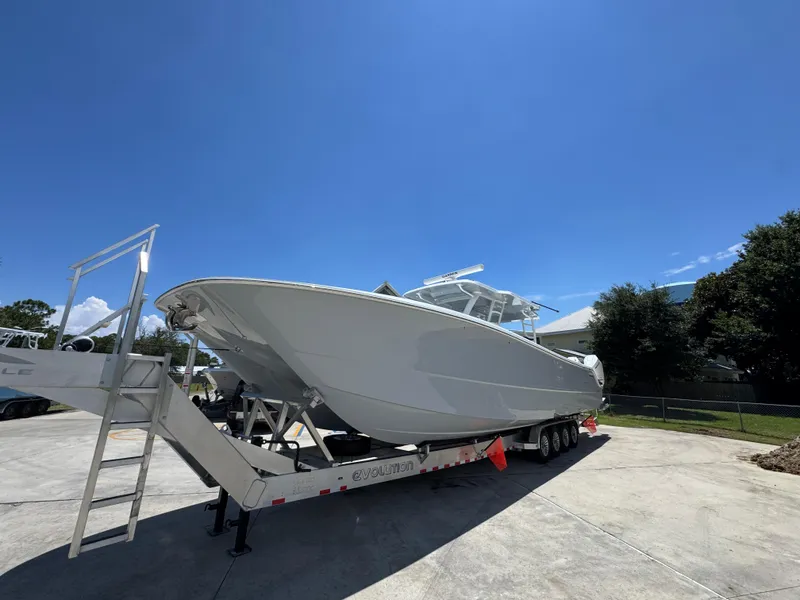 Slide: The Image of 2026 Invincible 46 Catamaran on trailer under clear blue sky. - 4