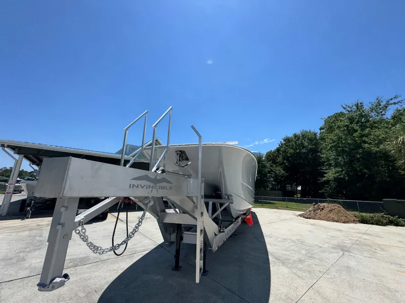 Slide: The Image of 2026 Invincible 46 Catamaran on trailer under clear blue sky. - 6