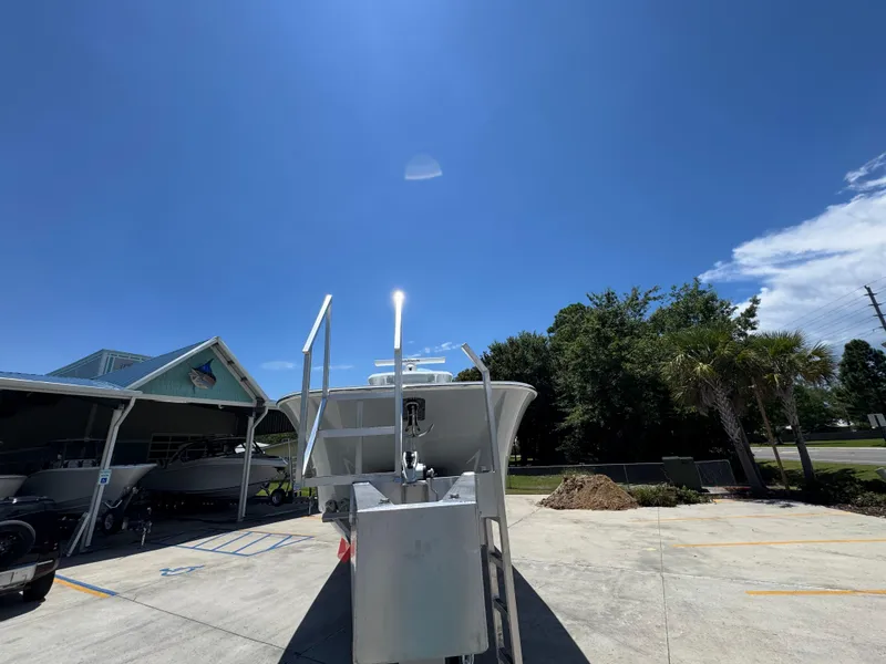 Slide: The Image of 2026 Invincible 46 Catamaran parked outdoors under clear blue sky. - 7
