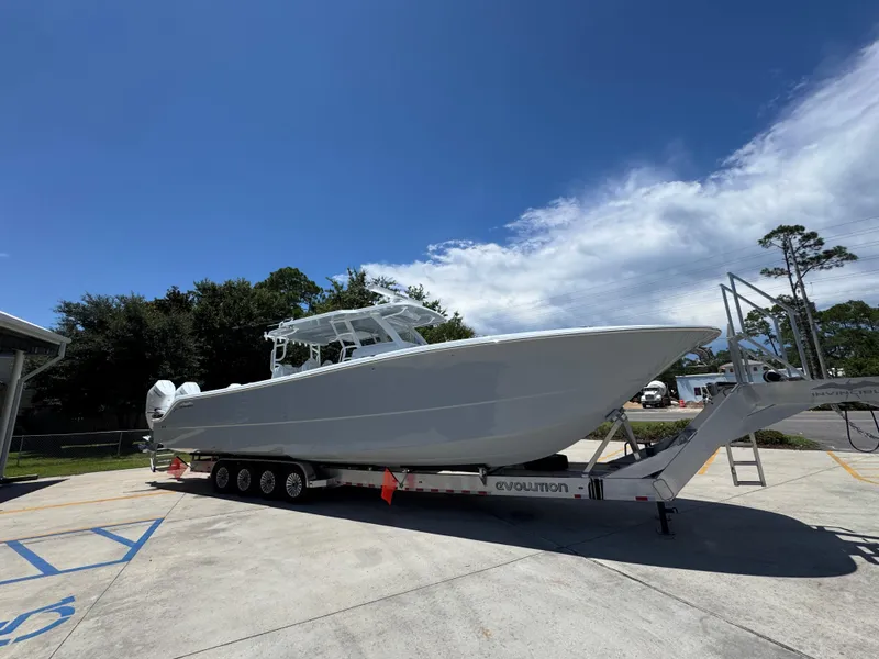 Slide: The Image of 2026 Invincible 46 Catamaran on trailer under clear blue sky. - 9