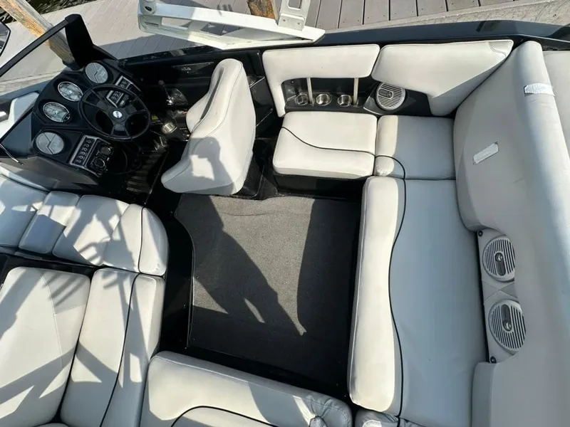 Slide: The Image of 2013 Axis A20 boat interior with white seating and dashboard controls. - 15