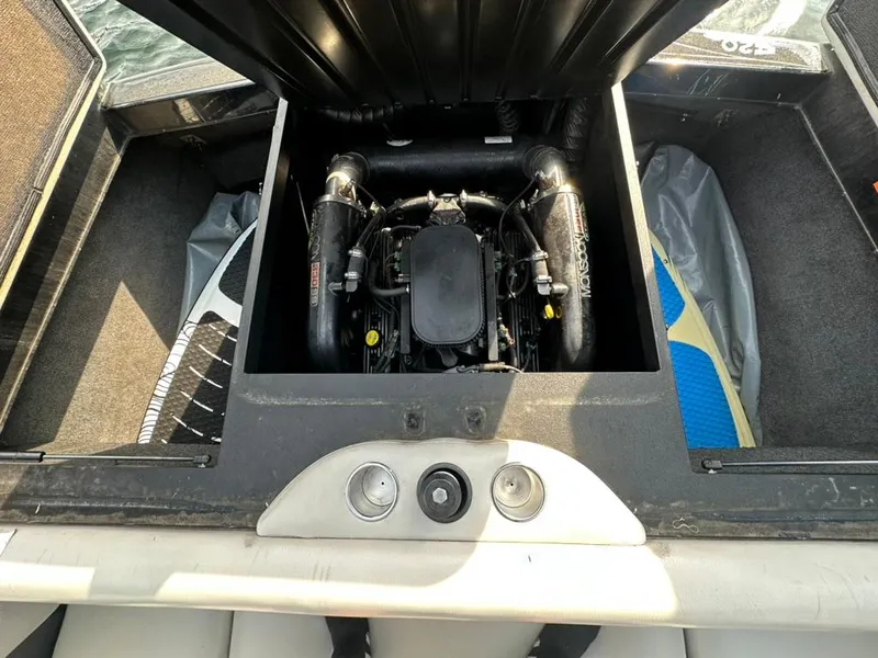Slide: The Image of Engine compartment of a 2013 Axis A20 boat, showcasing the engine and storage area. - 17