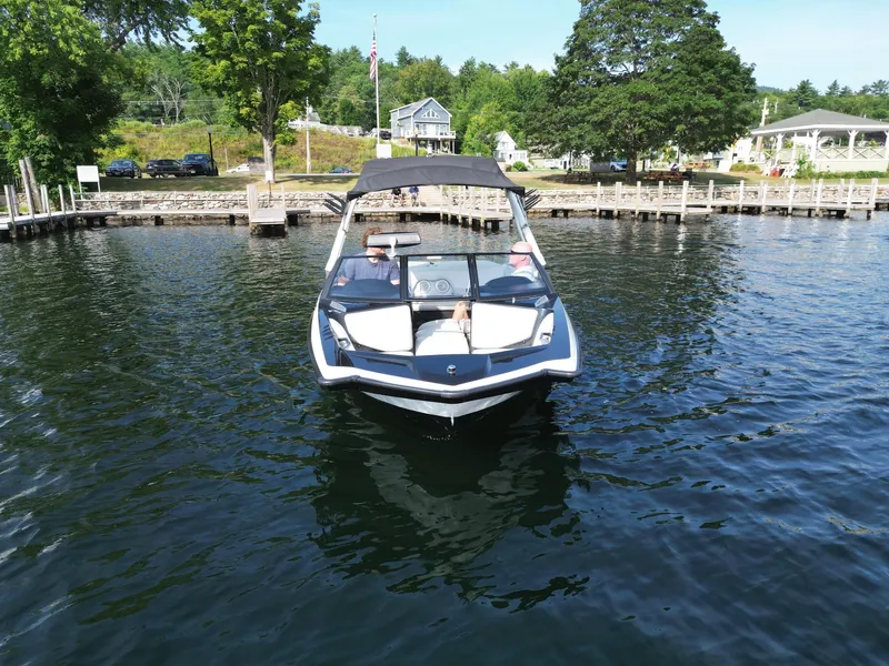 Slide: The Image of 2013 Axis A20 boat on a lake near a dock and trees. - 8