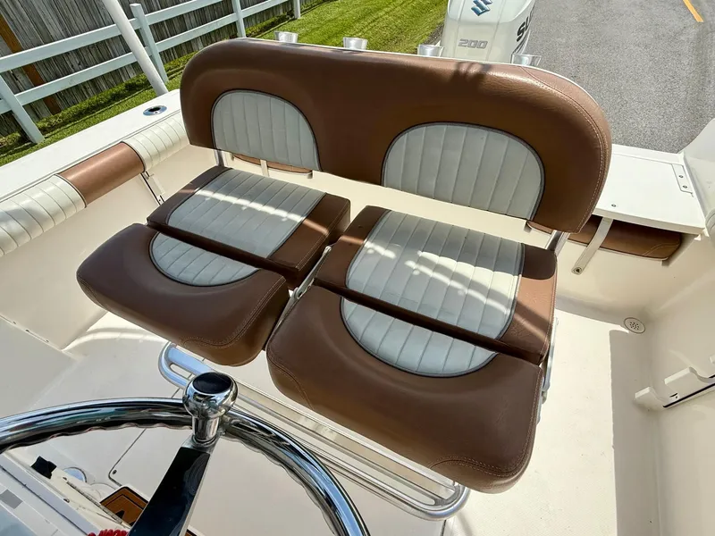 Slide: The Image of 2019 Sea Born LX21 Center Console boat seats with brown and white upholstery. - 10