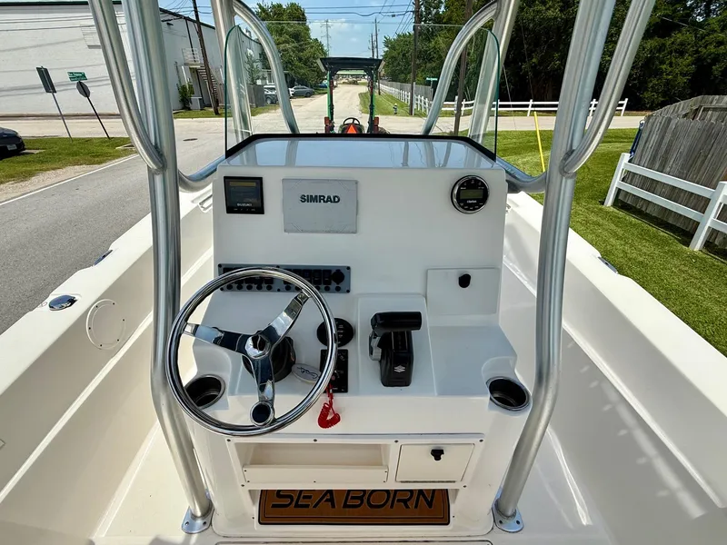 Slide: The Image of 2019 Sea Born LX21 Center Console boat interior with steering wheel and controls. - 11