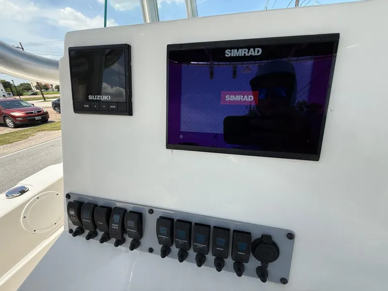 Slide: The Image of 2019 Sea Born LX21 Center Console dashboard with Simrad and Suzuki displays. - 17
