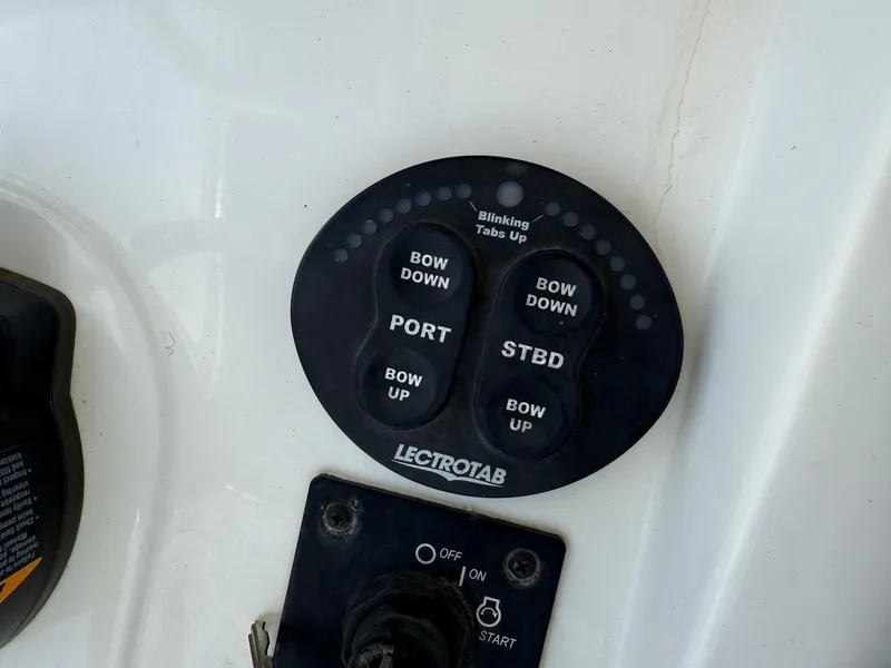 Slide: The Image of Control panel of a 2019 Sea Born LX21 Center Console boat with trim tab switches. - 19
