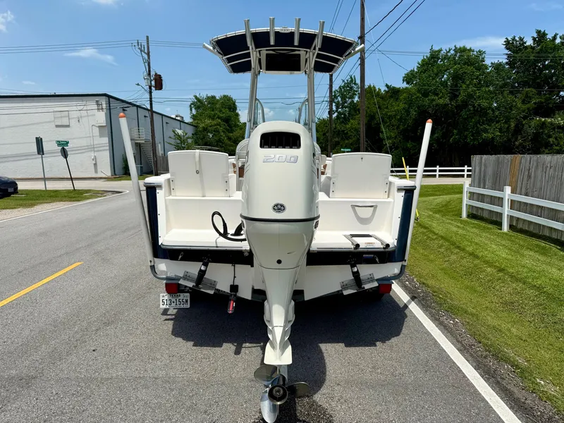 Slide: The Image of 2019 Sea Born LX21 Center Console boat on trailer, rear view, parked on street. - 3