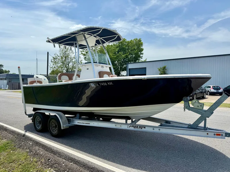 Slide: The Image of 2019 Sea Born LX21 Center Console boat on trailer, parked outdoors. - 5