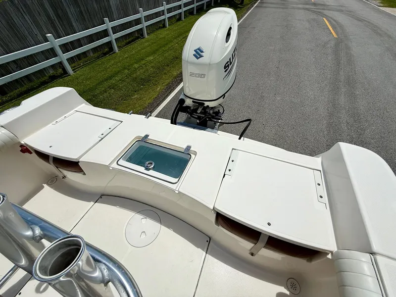 Slide: The Image of 2019 Sea Born LX21 Center Console boat with Suzuki engine on a road. - 8