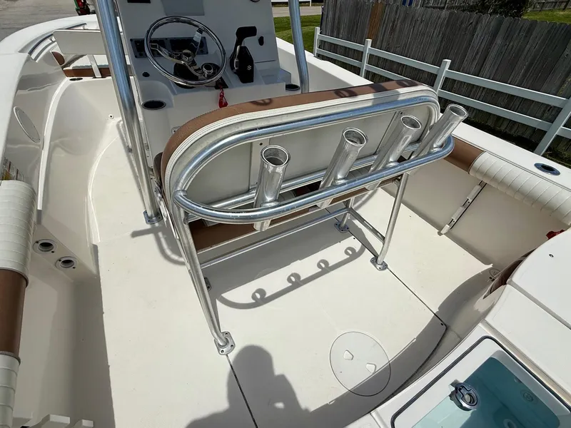 Slide: The Image of 2019 Sea Born LX21 Center Console boat interior with steering wheel and rod holders. - 9
