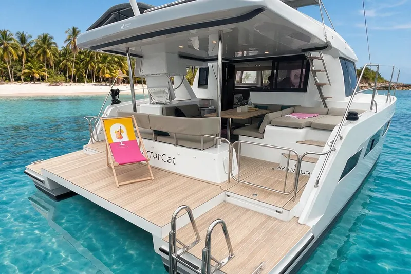 Slide: The Image of Aventura 37 Explorer Trawler 2026 docked by tropical beach, featuring spacious deck and seating. - 0
