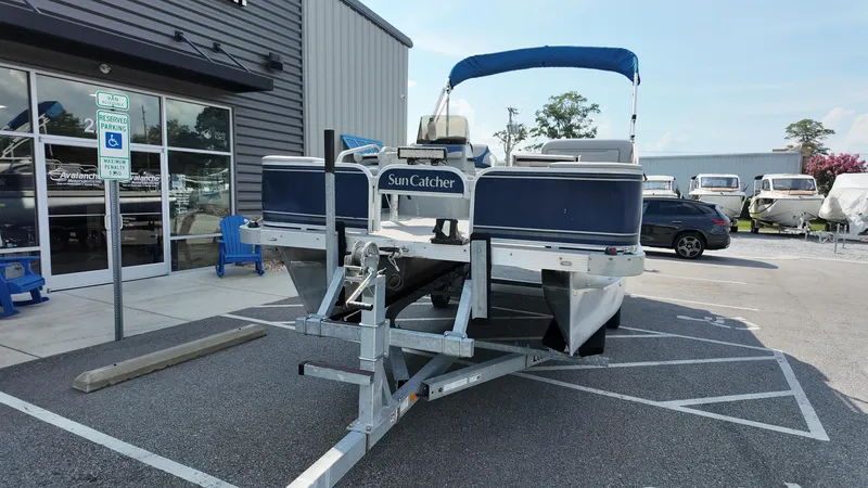 Slide: The Image of 2012 G3 SunCatcher LV 228 Fish & Cruise pontoon boat on trailer outside dealership. - 10