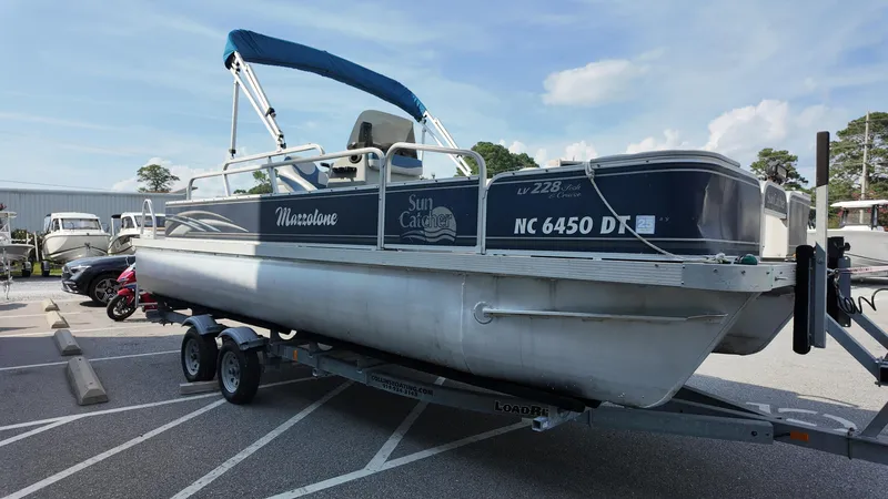 Slide: The Image of 2012 G3 SunCatcher LV 228 Fish & Cruise pontoon boat on trailer in parking lot. - 9