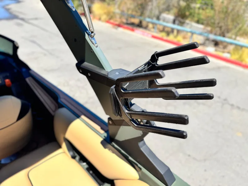 Slide: The Image of 2022 MB F21 Tomcat wakeboard tower with board rack, beige interior, outdoor setting. - 12