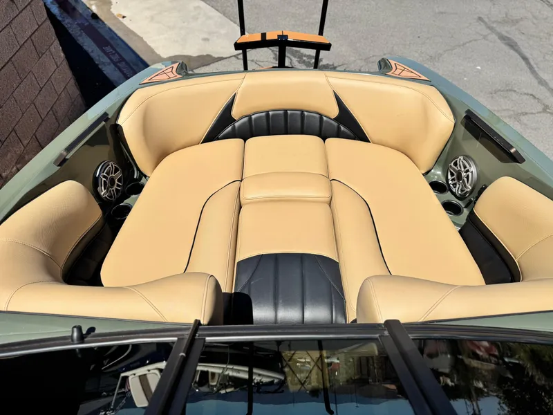 Slide: The Image of 2022 MB F21 Tomcat boat interior with beige and black seating, featuring built-in speakers. - 15