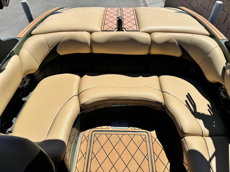 Slide: The Image of 2022 MB F21 Tomcat boat interior with tan leather seating and wood accents. - 19