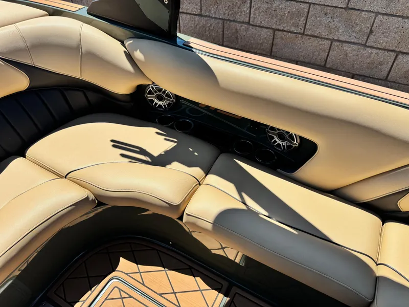 Slide: The Image of Luxurious interior of 2022 MB F21 Tomcat boat with beige seating and speakers. - 21