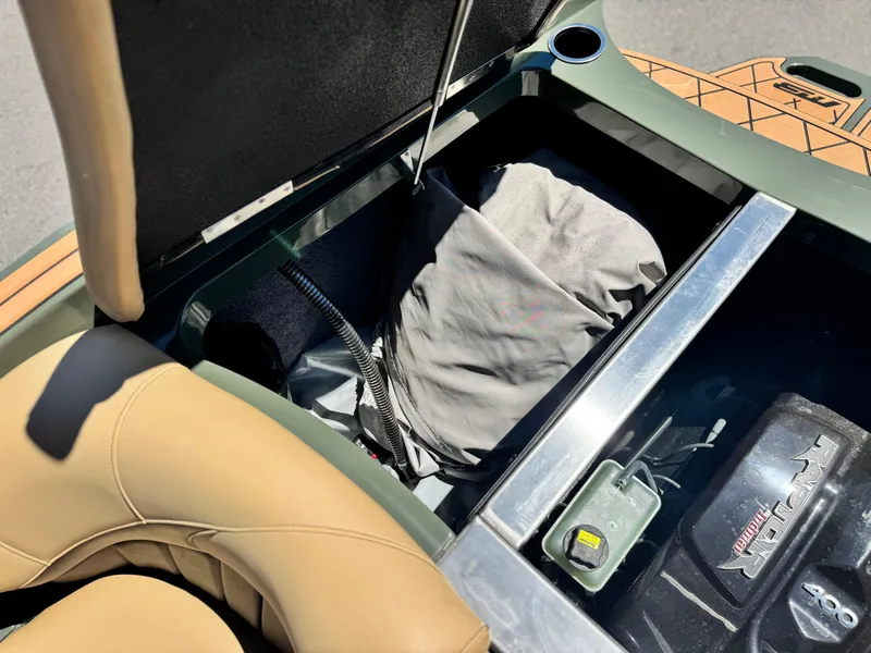 Slide: The Image of Open storage compartment in 2022 MB F21 Tomcat boat, showing engine and interior details. - 26