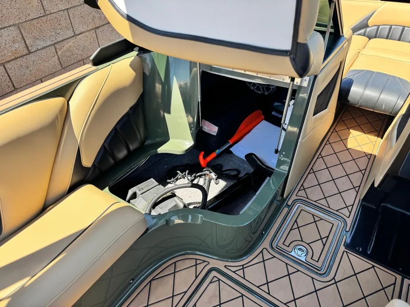 Slide: The Image of 2022 MB F21 Tomcat interior storage compartment with beige and black seating, open hatch, and accessories. - 29