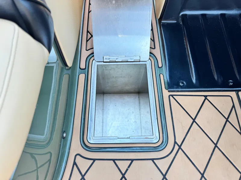Slide: The Image of 2022 MB F21 Tomcat boat storage compartment with open lid, featuring stylish interior design. - 33