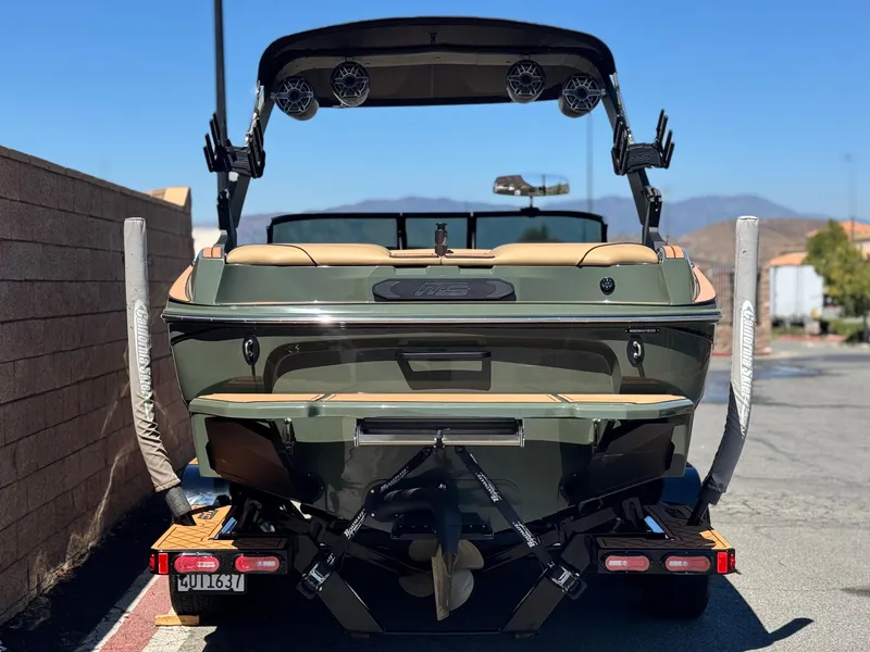 Slide: The Image of 2022 MB F21 Tomcat boat on trailer, rear view, parked outdoors. - 4