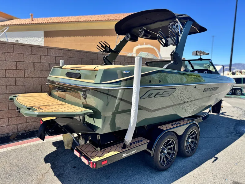 Slide: The Image of 2022 MB F21 Tomcat boat on trailer, parked outdoors, featuring sleek design and modern accessories. - 5