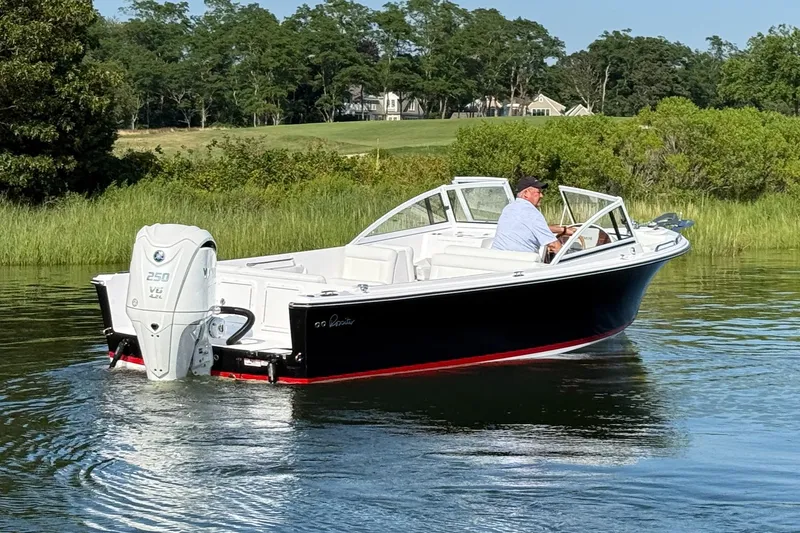 Slide: The Image of 2026 Rossiter 23 OPEN boat cruising on a calm lake with lush greenery. - 11