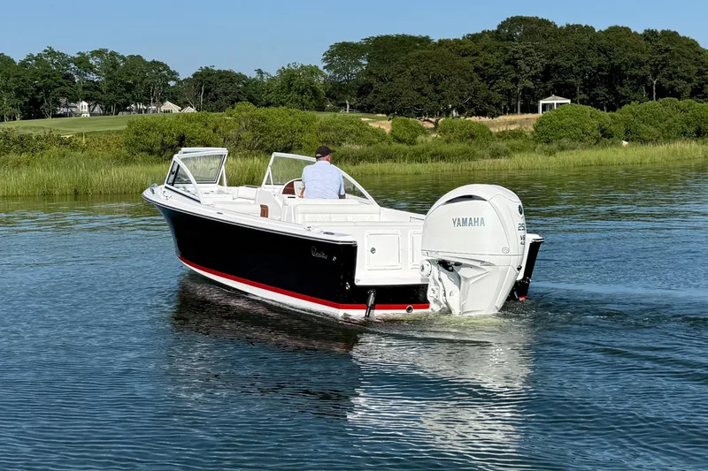 Slide: The Image of 2026 Rossiter 23 OPEN boat cruising on a calm lake with lush greenery. - 15