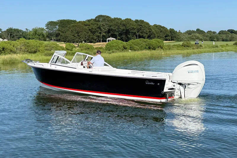 Slide: The Image of 2026 Rossiter 23 OPEN boat cruising on a calm river with lush greenery. - 16