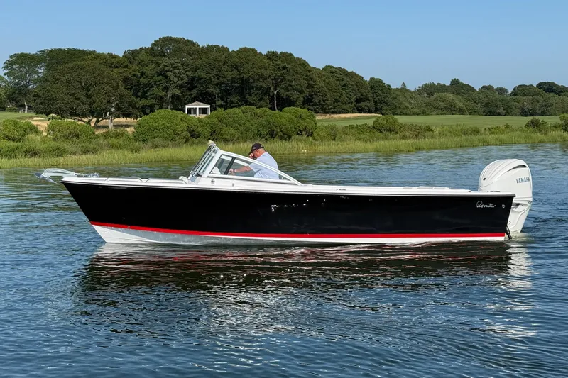 Slide: The Image of 2026 Rossiter 23 OPEN boat cruising on a calm lake with lush greenery. - 17