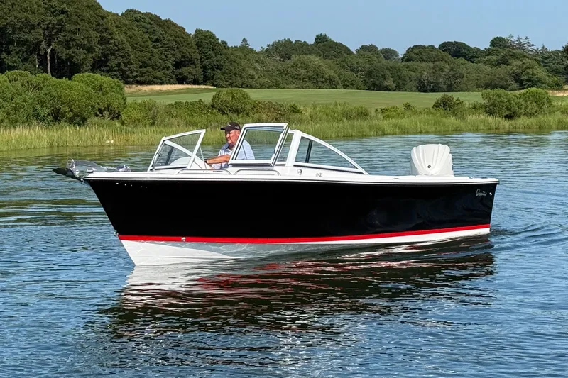 Slide: The Image of 2026 Rossiter 23 OPEN boat cruising on a calm lake with lush greenery. - 3