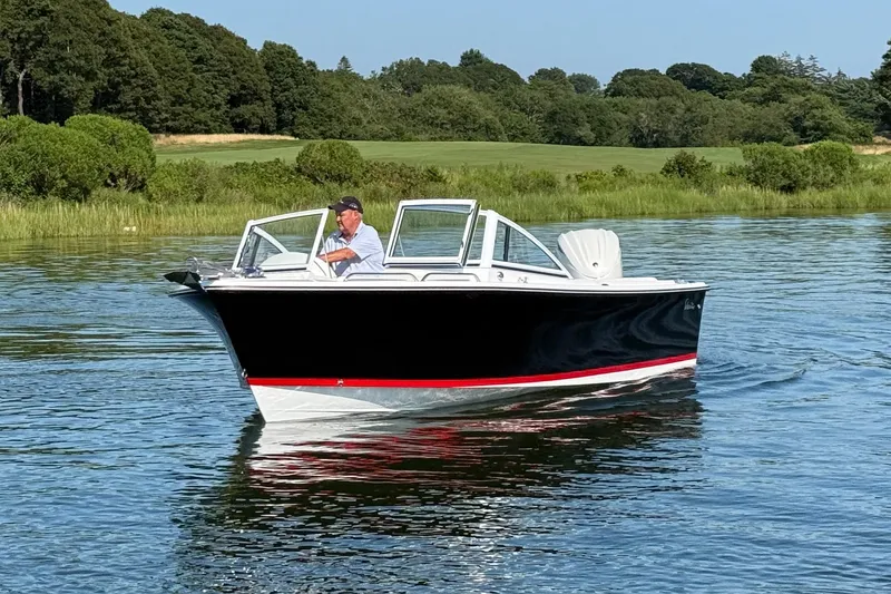 Slide: The Image of 2026 Rossiter 23 OPEN boat cruising on a calm lake with lush greenery. - 4