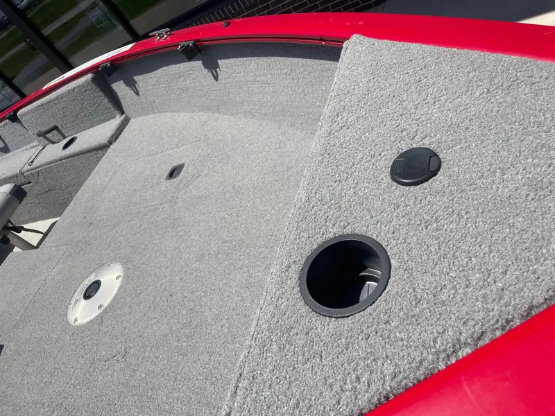 Slide: The Image of 2012 Tracker Pro Guide 175 boat interior with gray carpet and red trim. - 3