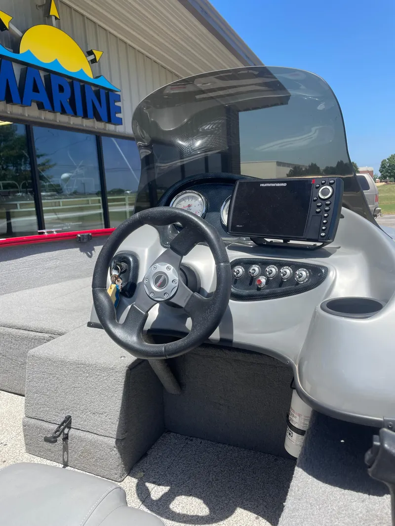 Slide: The Image of 2012 Tracker Pro Guide 175 boat dashboard with steering wheel and navigation system. - 8