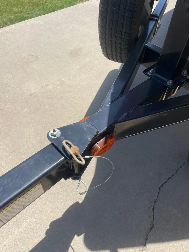 Slide: The Image of Trailer hitch of a 2012 Tracker Pro Guide 175 on concrete driveway. - 9
