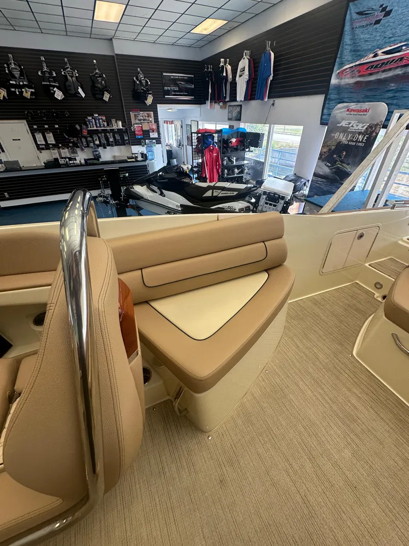 Slide: The Image of 2024 Chris-Craft Launch 25 GT interior with beige seating in a showroom setting. - 17