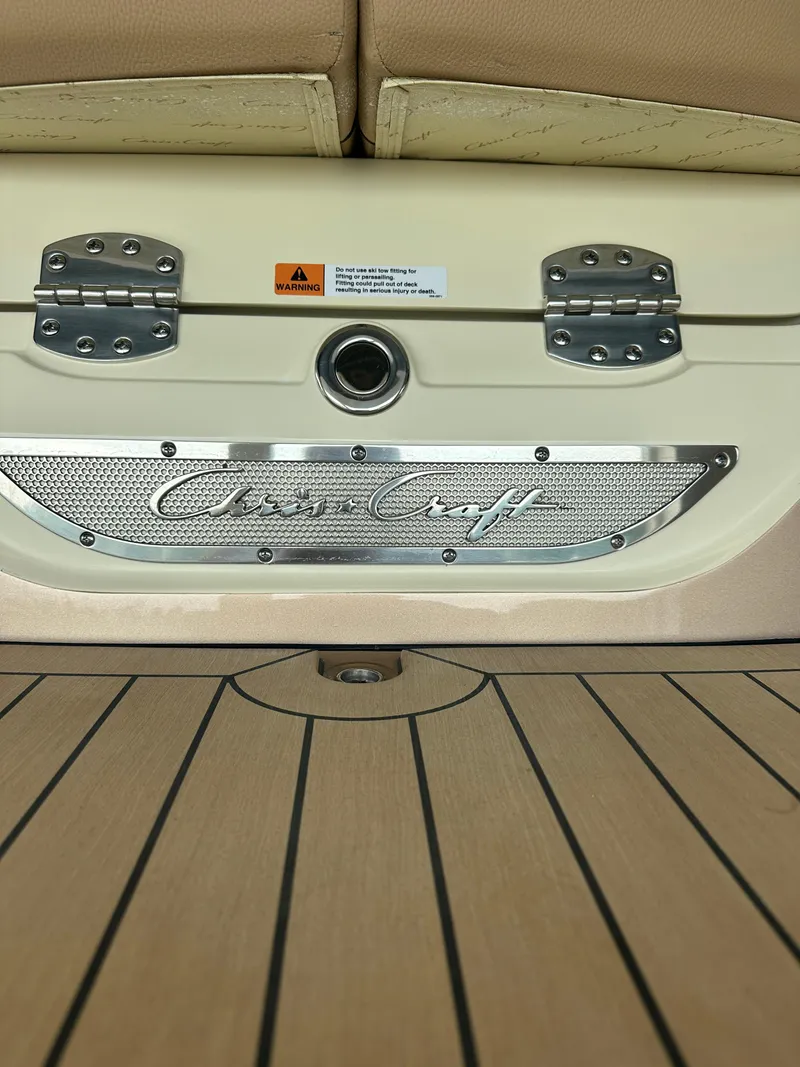 Slide: The Image of 2024 Chris-Craft Launch 25 GT boat interior with logo and wooden deck. - 25