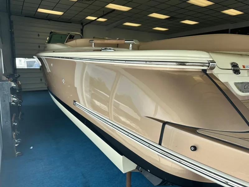 Slide: The Image of 2024 Chris-Craft Launch 25 GT boat in showroom, side view. - 26