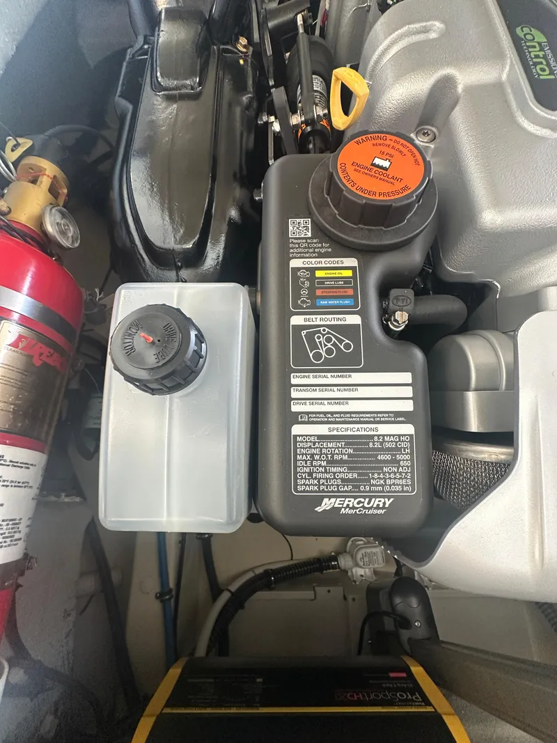 Slide: The Image of Engine compartment of 2024 Chris-Craft Launch 25 GT with Mercury components and fire extinguisher. - 28