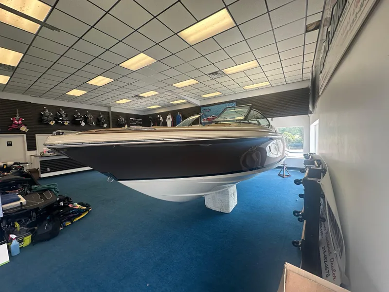 Slide: The Image of 2024 Chris-Craft Launch 25 GT boat displayed indoors, showcasing sleek design and craftsmanship. - 3