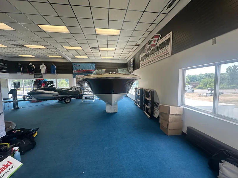 Slide: The Image of 2024 Chris-Craft Launch 25 GT displayed in a showroom with blue carpet. - 4