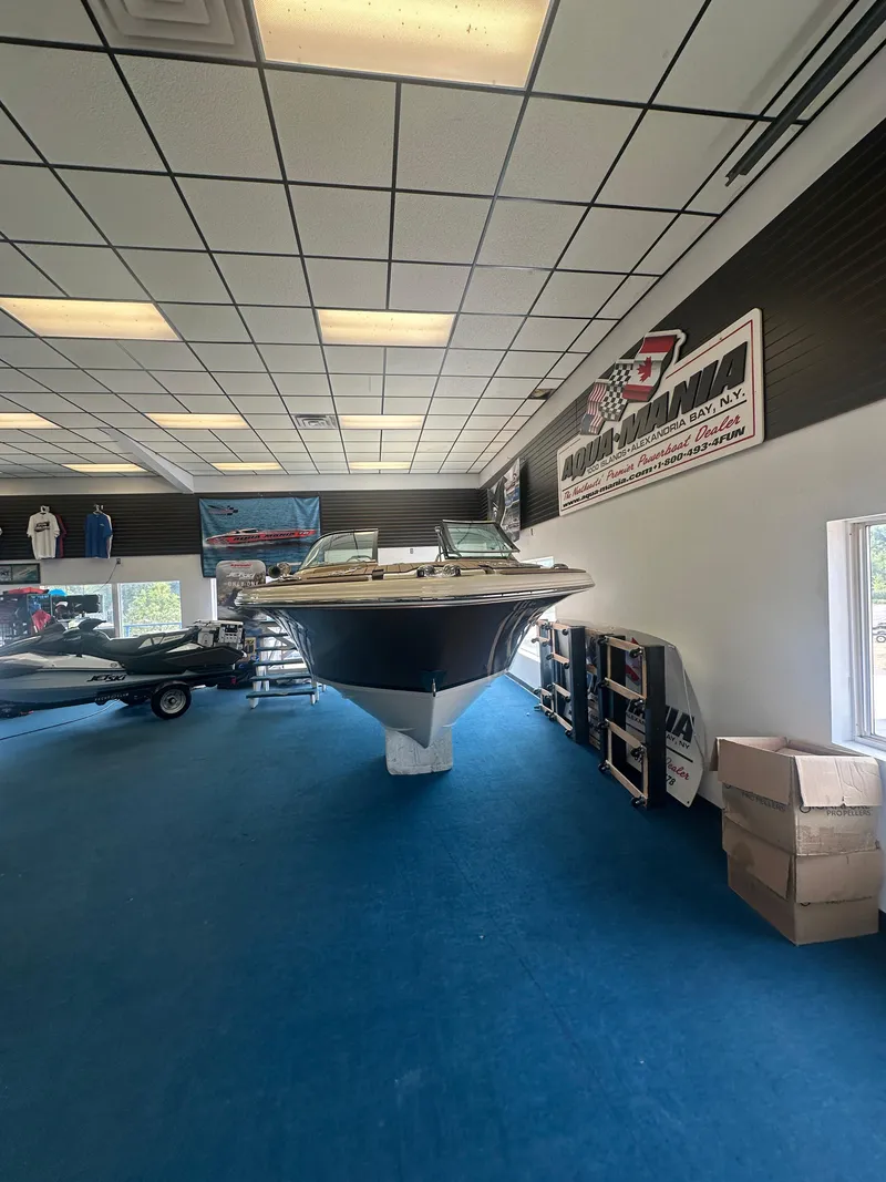 Slide: The Image of 2024 Chris-Craft Launch 25 GT boat displayed in showroom with blue carpet and promotional signage. - 5