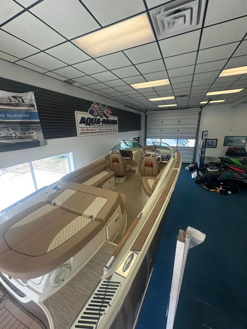 Slide: The Image of 2024 Chris-Craft Launch 25 GT boat displayed in showroom with elegant interior design. - 6