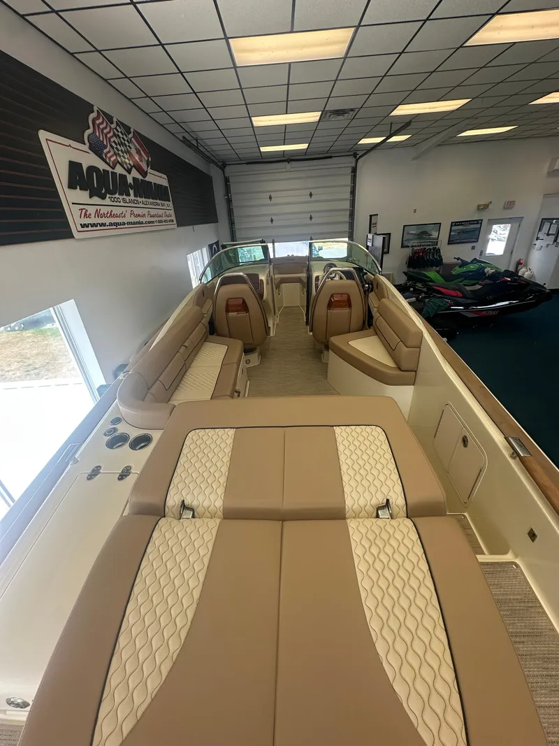 Slide: The Image of 2024 Chris-Craft Launch 25 GT boat interior with luxurious seating in showroom. - 7