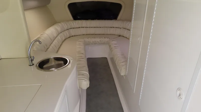 Slide: The Image of 1998 Hustler 388 SLINGSHOT interior with beige seating and compact sink. - 10