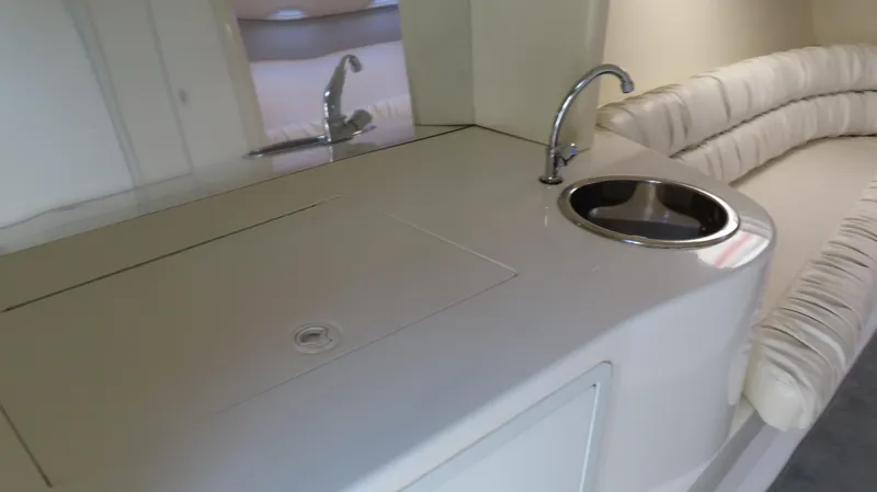 Slide: The Image of Interior of 1998 Hustler 388 SLINGSHOT with sink and cushioned seating. - 11