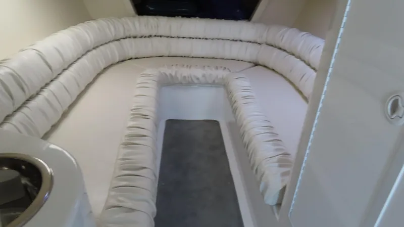 Slide: The Image of Interior cabin of 1998 Hustler 388 SLINGSHOT with white cushioned seating. - 13